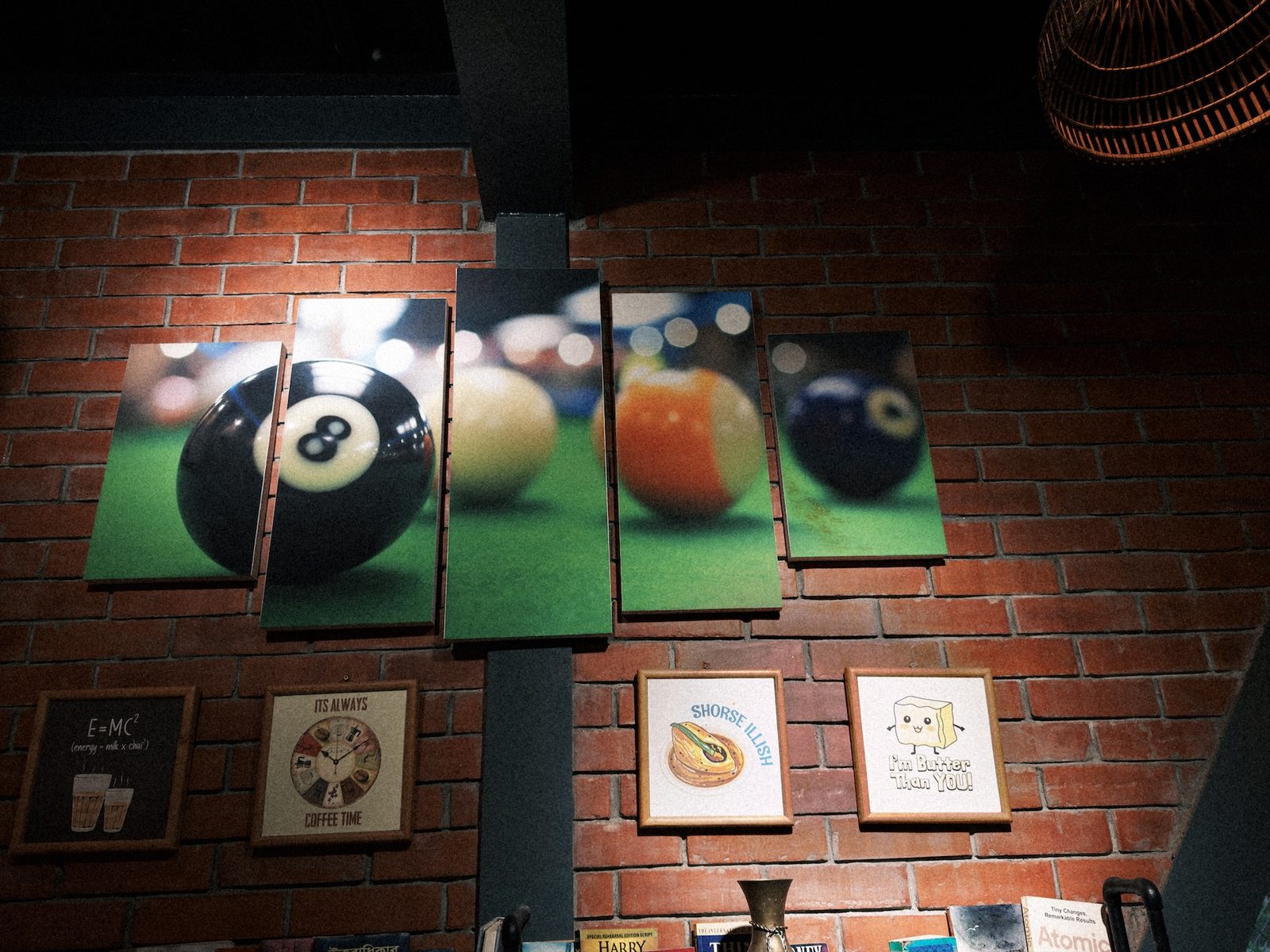 The same wall with the framed pictures readable and the brick around them evened out
