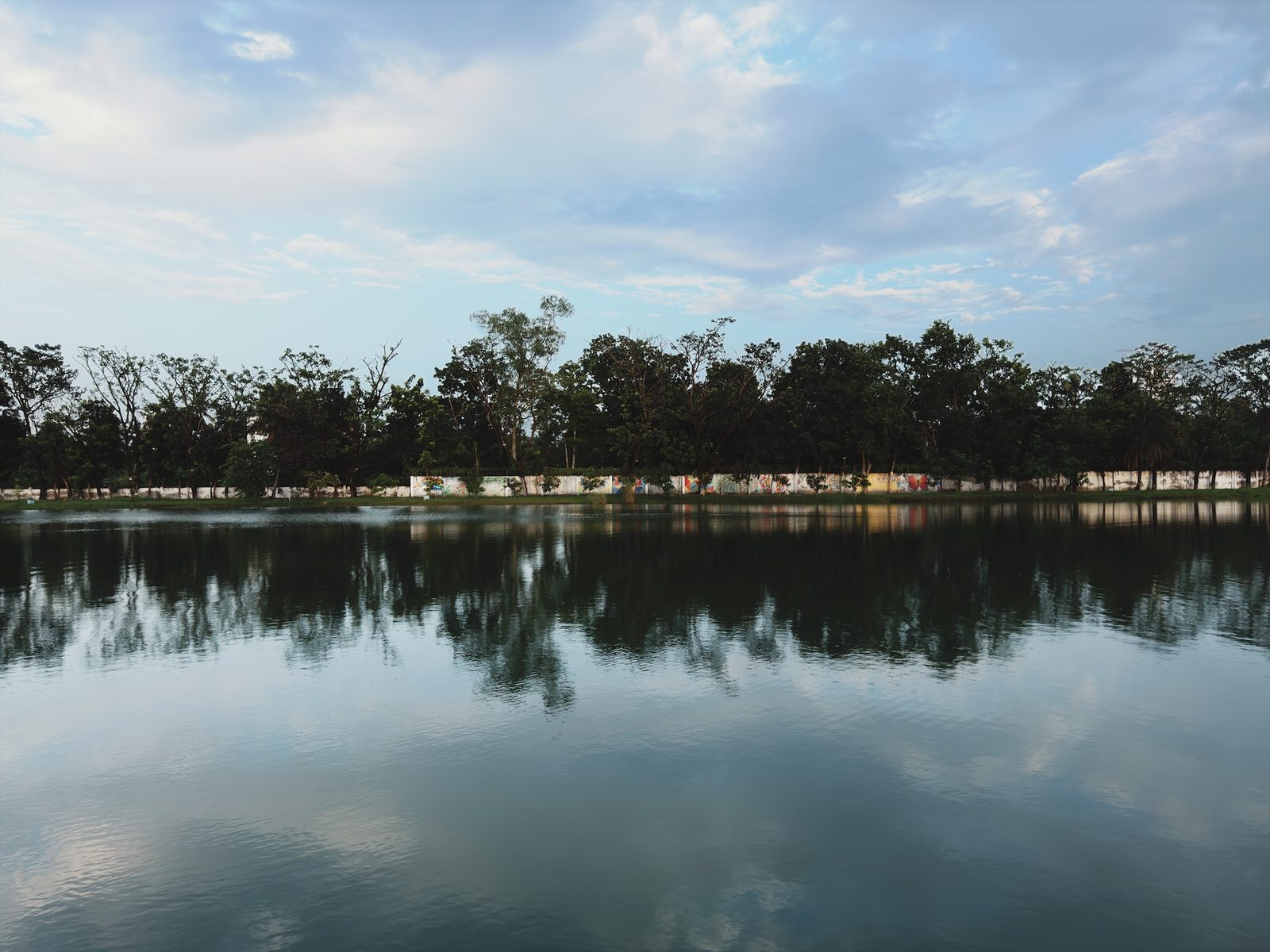 The same lake with blue sky and clearly defined clouds
